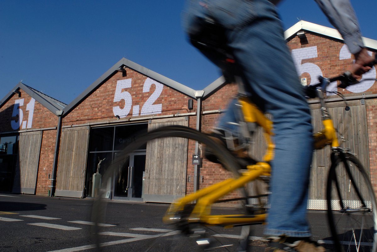 Blurred cyclist in front of Paintworks buildings