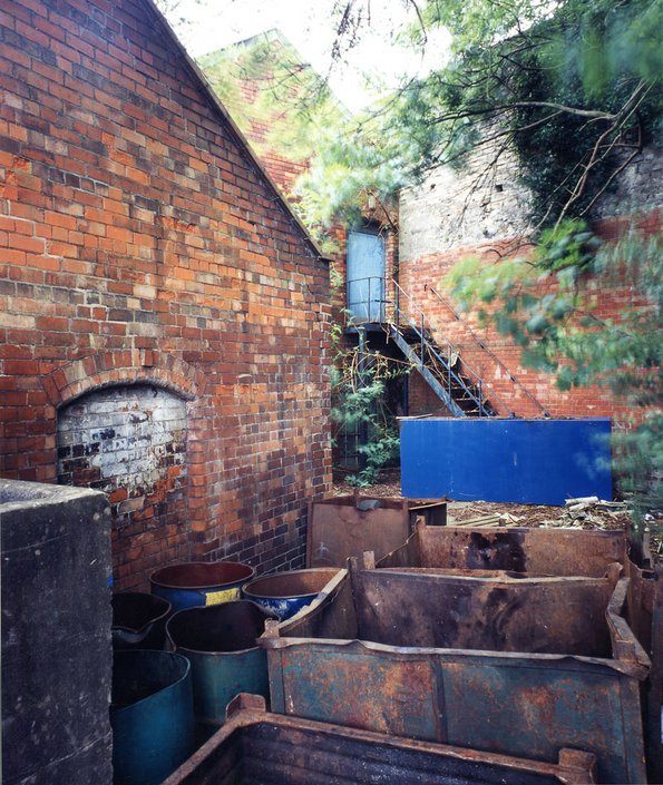 Oil drums beside weathered building